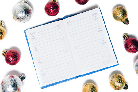 agenda surrounded with xmas balls isolated on a white background.の写真素材