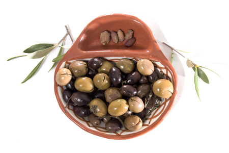 Green and black olives seasoned isolated on a white background.の写真素材