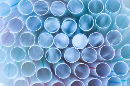 Bunch of drinking straws isolated on a blue background.の写真素材