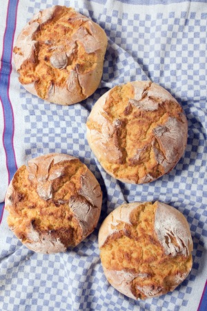 Traditional Portuguese Corn Bread on a blue cloth fabric.