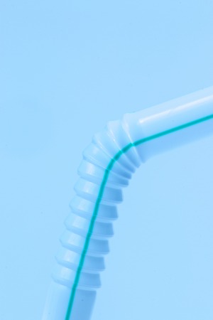 drinking straw close up macro detail  isolated on a blue background.の写真素材