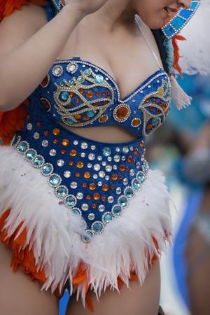 Colorful Carnival (Carnaval) Parade festival famel participant dancing.