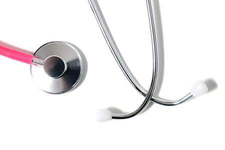 Close up view of a pink doctor's stethoscope isolated on a white background.の写真素材