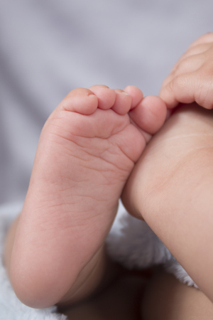 Close up of cute and tiny baby foot.の写真素材