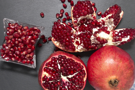 Close up view of tasty pommegranate fruit on top of a slate stone.の写真素材