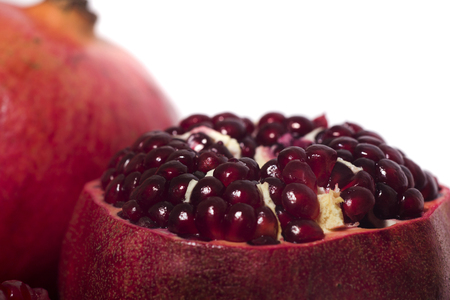 Close up view of tasty pommegranate fruit isolated on a white background.の写真素材