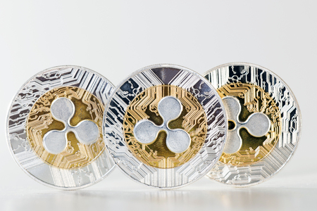 Shiny ripple coins on a white background.の写真素材