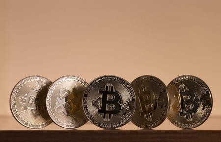 Shiny golden bitcoins on top of wooden table.の写真素材