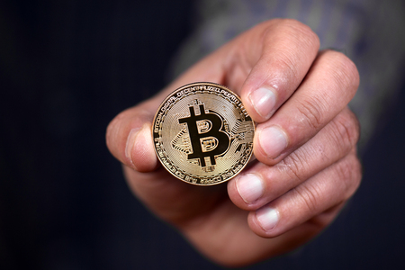 male hand holding a bitcoin, a digital crypto currency.の写真素材