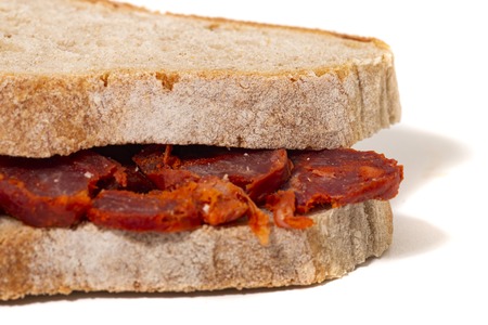 chorizo and traditional bread slices isolated on a white background.