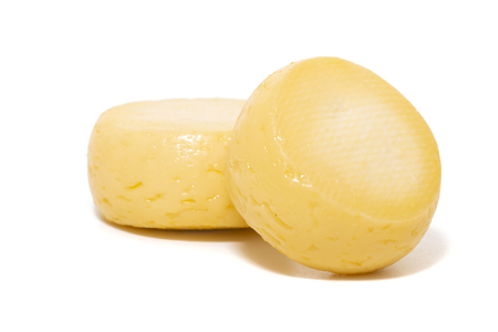 Yellow goat cheese isolated on a white background.の写真素材