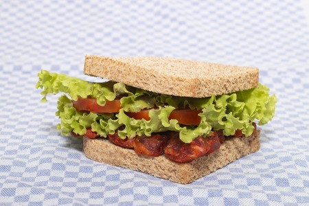 sandwich with smoked chorizo, tomato and lettuce.の写真素材