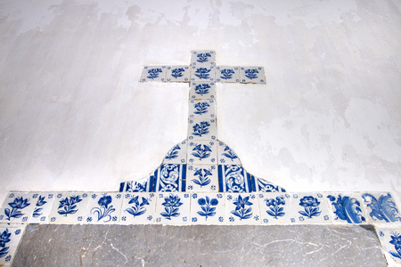 Christian cross made of azulejo tiles on the frame of a door.の写真素材