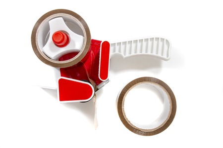 Brown adhesive packaging tape dispenser isolated on a white background.の写真素材