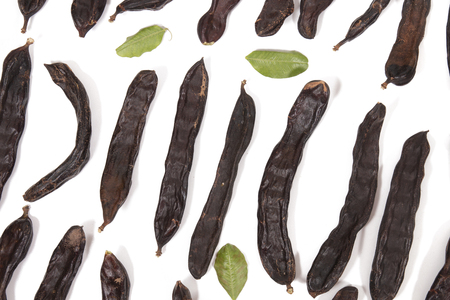 carob fruits assortment isolated over a white background.の写真素材