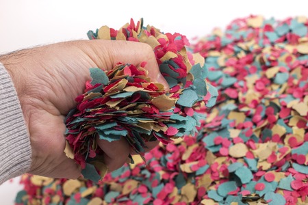 Hand grabs a mix of colorful confetti.の写真素材