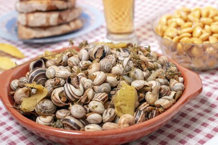 Traditional Portuguese dish of cooked snails and toasted bread and beer.