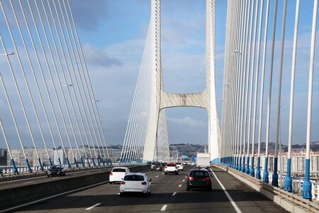 View of a traffic on the long bridge, Vasco da Gama, located in Portugal, Europe.の写真素材