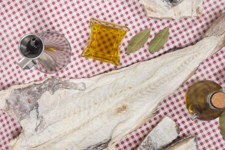 Close up view of a portuguese salted codfish on a table cloth.