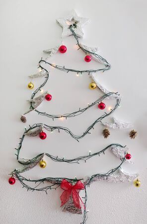diy christmas tree decoration on a white wall.の写真素材