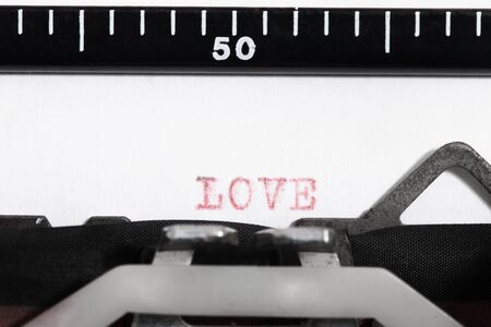 Vintage portable typewriter  with love word written.の写真素材