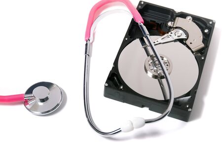 Close up view of a computer hard drive with pink stethoscope concept isolated on a white background.の写真素材