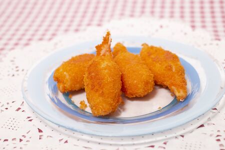 Tasty fried shrimp leg treats on a plate.の写真素材