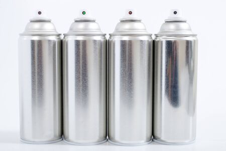 Close up view of silver spray cans on a white background.