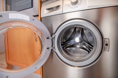 Close up view of a washing machine on the kitchen.の写真素材