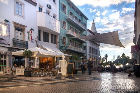 FARO, PORTUGAL - October 16, 2019: Tourist downtown area of Faro city with cobblestone streets and restaurants.のeditorial素材