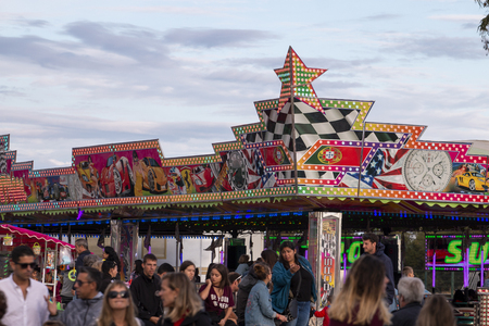 FARO, PORTUGAL - OCTOBER  2018: Fun fair event Santa Iria with games, street food, ferry wheels, bumper cars and many diverse activities.のeditorial素材