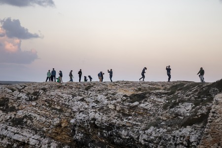 SAGRES, PORTUGAL: 28th of October, 2018 - People being playful on the strong winds of the coastline of Sagres, taking photos and resisting the winds.のeditorial素材