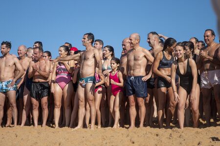 QUARTEIRA, PORTUGAL: 1st JANUARY, 2020 - People of all ages gather to an event for the first dive/plunge of the new year into the ocean water.のeditorial素材