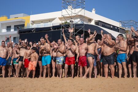 QUARTEIRA, PORTUGAL: 1st JANUARY, 2020 - People of all ages gather to an event for the first dive/plunge of the new year into the ocean water.のeditorial素材