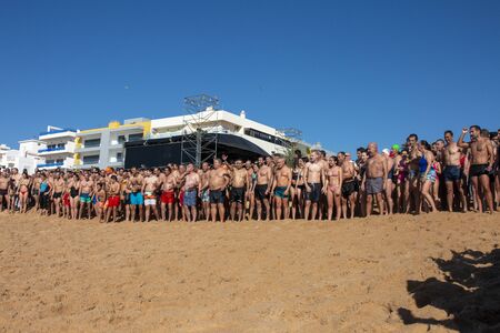 QUARTEIRA, PORTUGAL: 1st JANUARY, 2020 - People of all ages gather to an event for the first dive/plunge of the new year into the ocean water.のeditorial素材