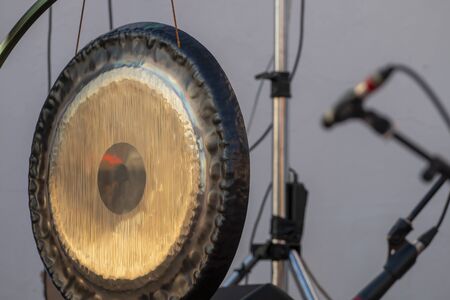 Close up of a big oriental metal musical instrument called, Gong, used for relaxation music and buddhists.のeditorial素材