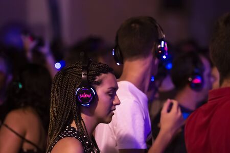 FARO, PORTUGAL: 6th SEPTEMBER, 2019 - Audience uses headphones in silent disco party concept on ...