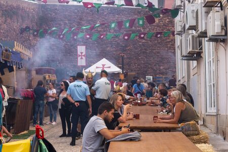 SILVES, PORTUGAL - August 11th, 2019 : Food court area of  Medieval festival where people eat...