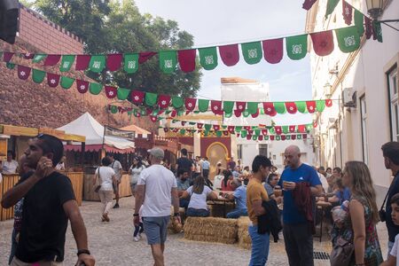 SILVES, PORTUGAL - August 11th, 2019 : Food court area of  Medieval festival where people eat grilled meat and other medieval meals.のeditorial素材