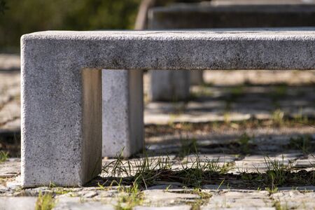 Stone cement bench on a park.