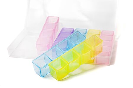 Colored pillbox organizer over a white background.