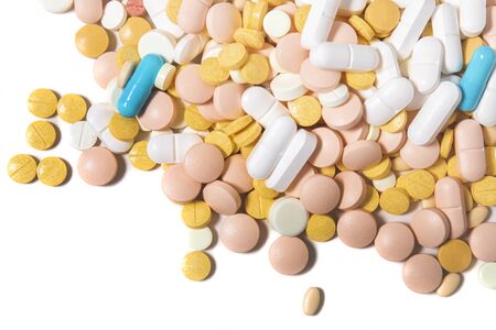Assorted mix of pills over a white background.