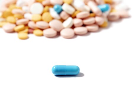 Assorted mix of pills over a white background.