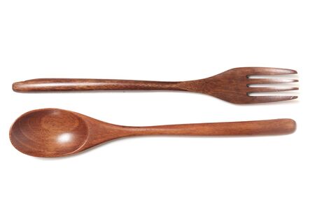 Close view of wooden fork and spoon over a white background.