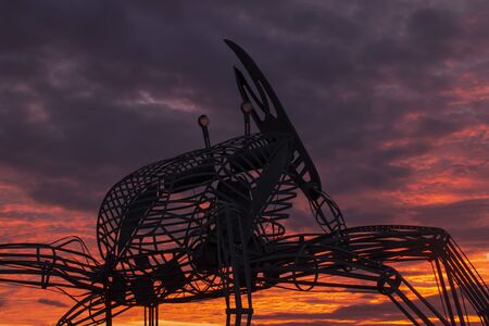 FARO, PORTUGAL: 8th DECEMBER 2019 - Crab statue in the natural marshlands at sunset located in Ria...