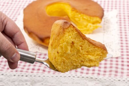 Pao de Lo de Ovar, typical cake of Portugal, on a red table cloth.