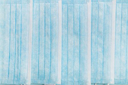 Medical protective masks isolated on a light blue background.