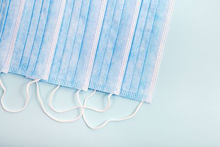 Medical protective masks isolated on a light blue background.