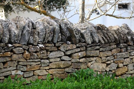 traditional slate stone wall on portuguese countryside on the algarve region.