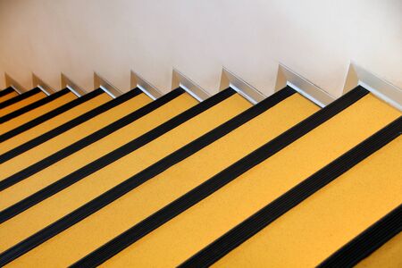 Close view of yellow stairs inside of office building.の写真素材